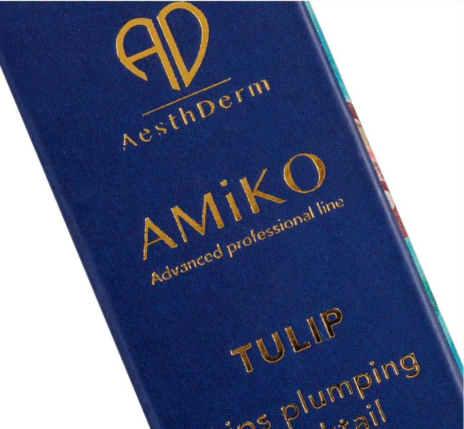 Close-up of a blue cosmetic package with gold lettering reading AesthDerm, AMiKO, and TULIP on a white background.