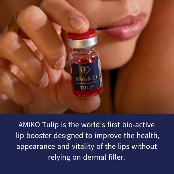 A close-up of a hand holding a small vial labeled AMiKO Tulip, with part of a person's face visible. A dark blue text banner at the bottom reads: 'AMIKO Tulip is the world's first bio-active lip booster designed to improve the health, appearance and vitality of the lips without relying on dermal filler.